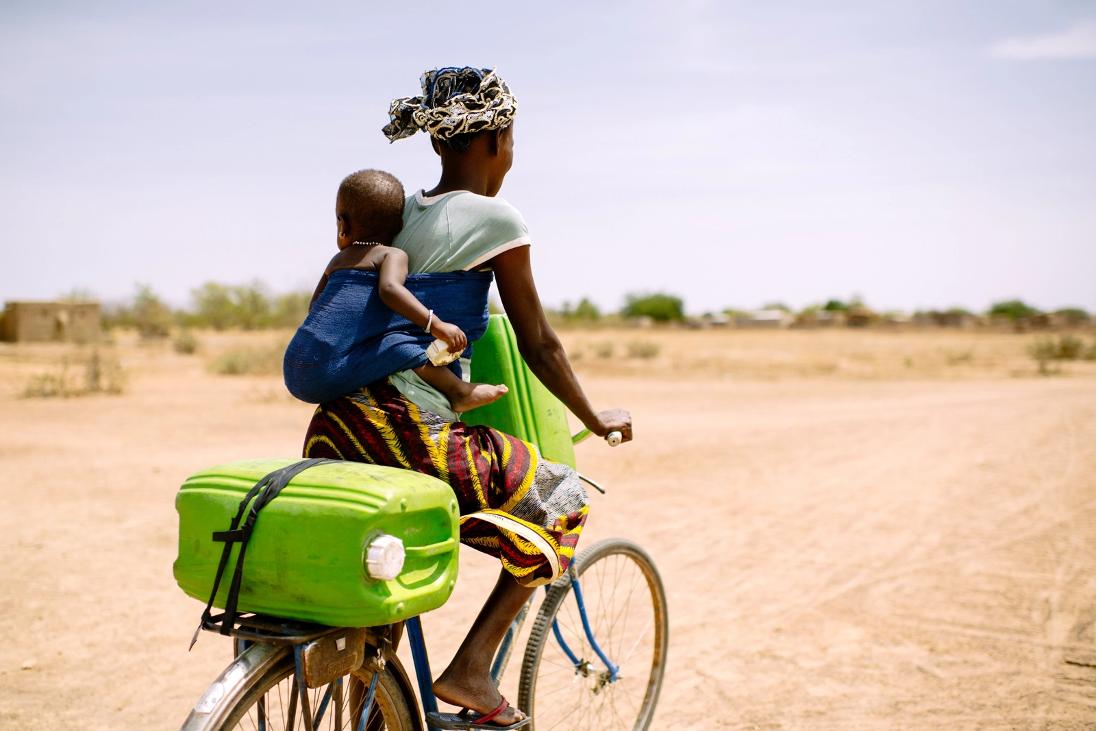 A woman rides to collect water for her family in the village of Sorobouly, Burkina Faso. In developing countries, the livelihoods of women, who often work in the informal sector, are more vulnerable to economic and environmental shocks. (Image: Ollivier Girard/CIFOR, CC BY-NC-ND-2.0)
