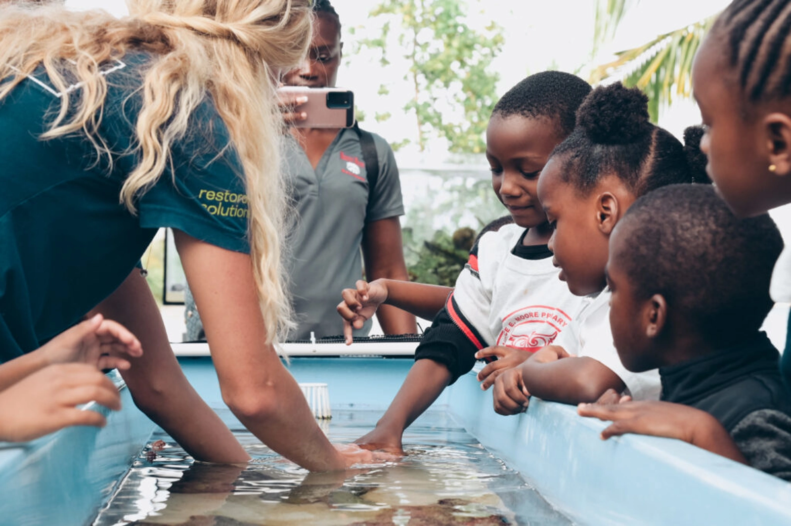 Image: Coral Vita. School children experiencing our touch tank and interacting with marine life possibly for the first time.
